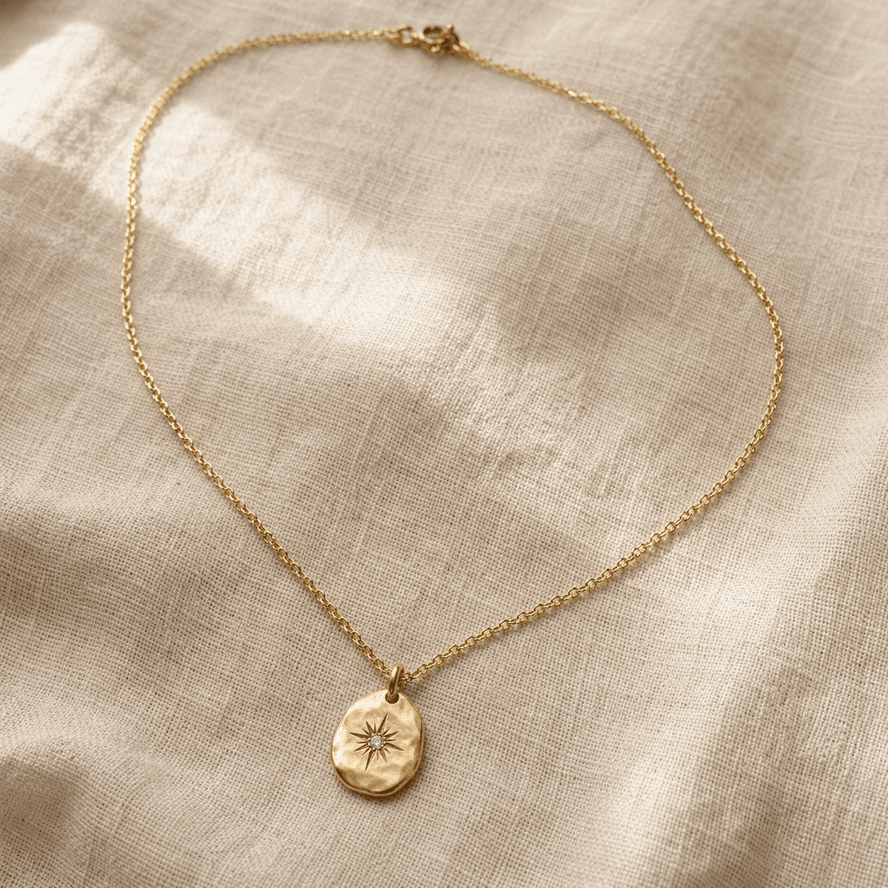 Empty-cart category pick: pendant flat-lay on warm bone linen.